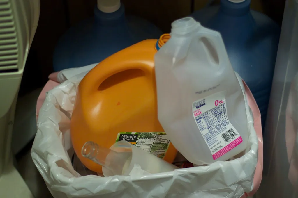 Used plastic jugs and bottles gathered in a bag for recycling